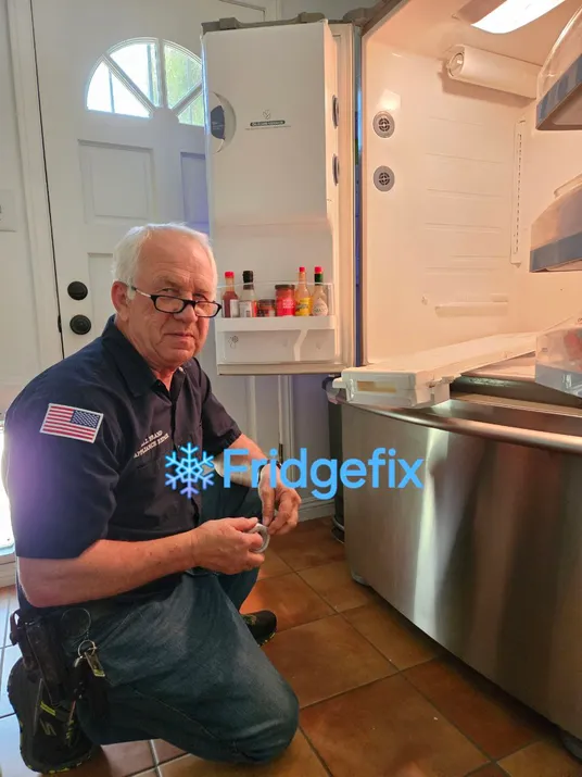 One of our technicians, repairing a freezer