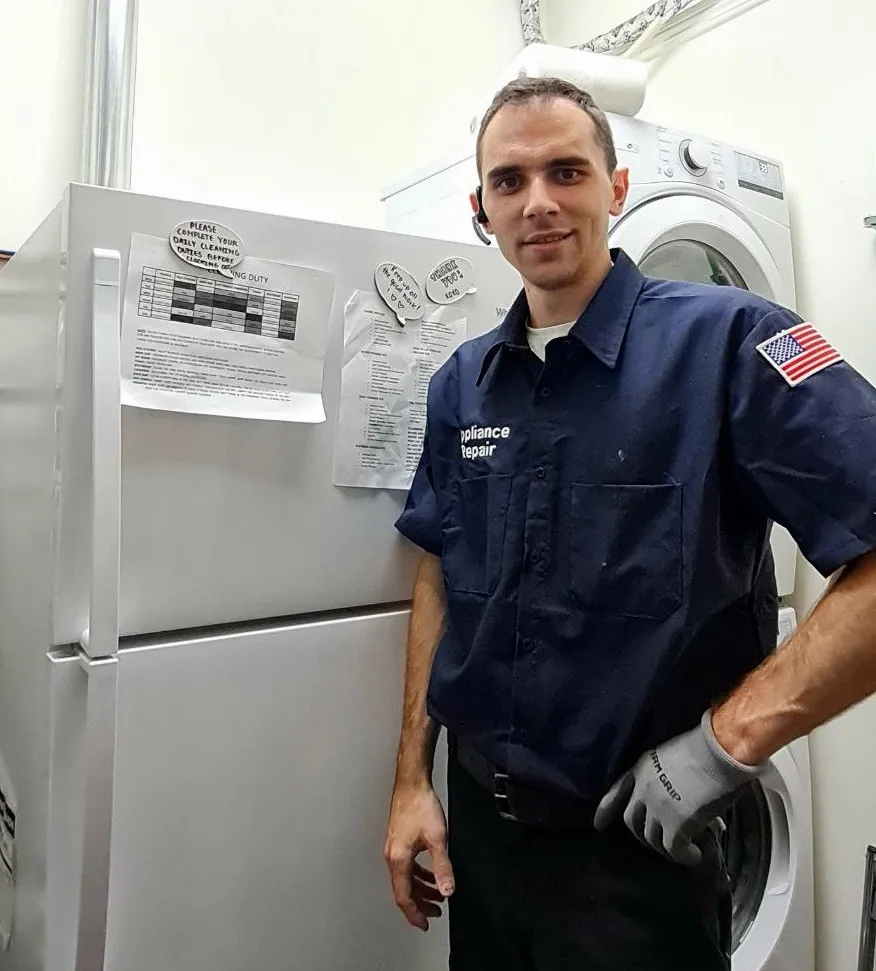 Technician Ivan, FridgeFix owner and operator, standing next to a fridge